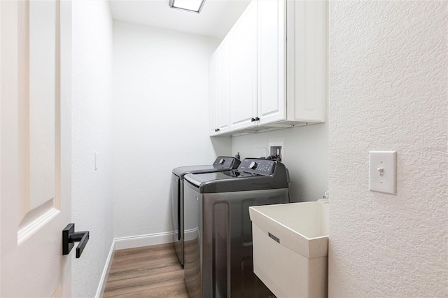 1711 Boca Raton Ct, Punta Gorda, FL 33950 - washroom featuring baseboards, light wood finished floors, a sink, washer and clothes dryer, and cabinet space