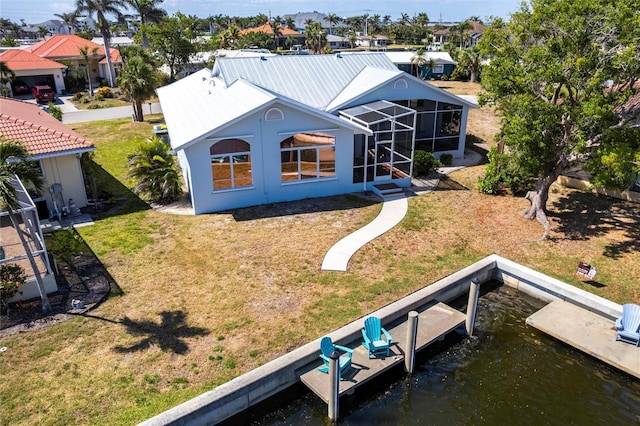 1711 Boca Raton Ct, Punta Gorda, FL 33950 - back of house featuring metal roof, a lanai, and a lawn