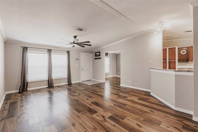 unfurnished living room with visible vents, a ceiling fan, dark wood-style flooring, and crown molding