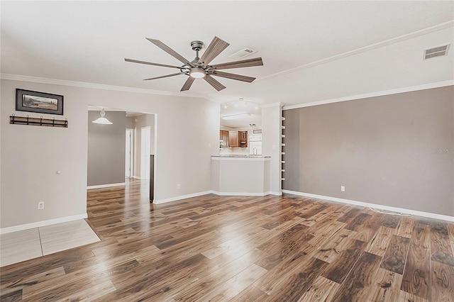 unfurnished living room featuring crown molding, ceiling fan, baseboards, wood finished floors, and visible vents