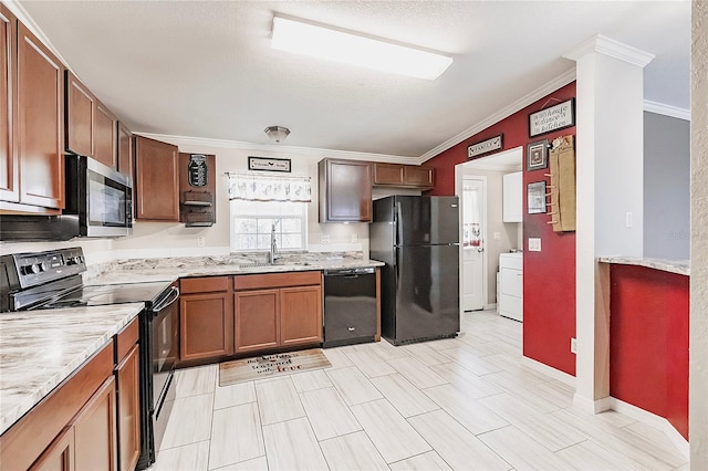 kitchen featuring light stone counters, a sink, washer / clothes dryer, ornamental molding, and black appliances