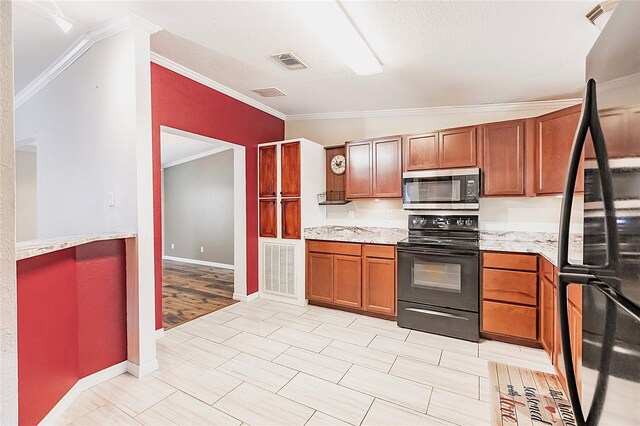 kitchen featuring crown molding, brown cabinetry, black appliances, and visible vents