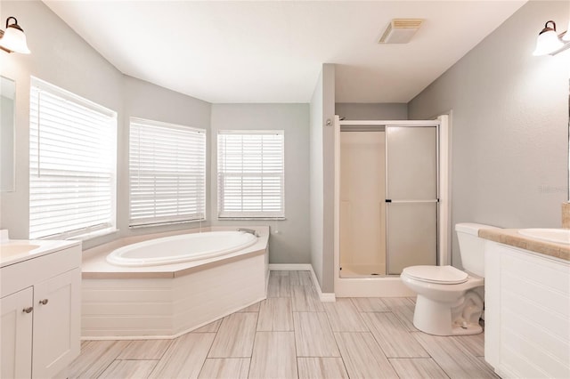 full bath featuring vanity, a bath, a stall shower, and visible vents