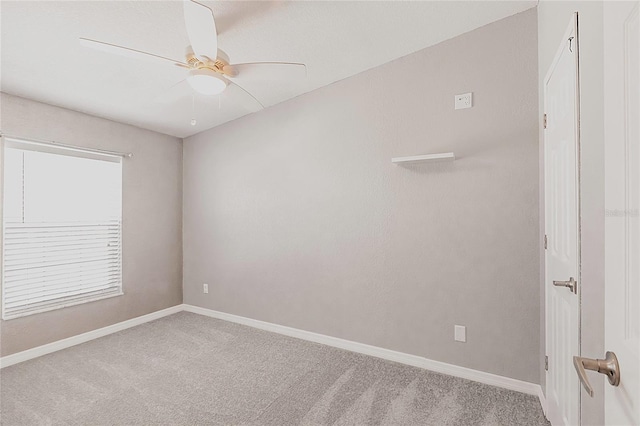unfurnished room with baseboards, a ceiling fan, and carpet flooring