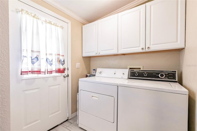 laundry room with separate washer and dryer, ornamental molding, and cabinet space