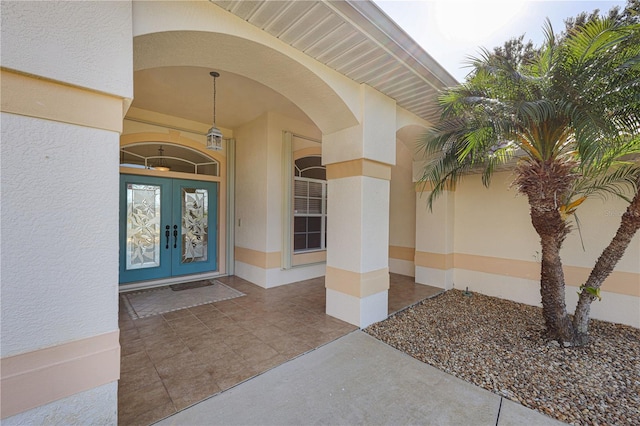 property entrance with french doors and stucco siding