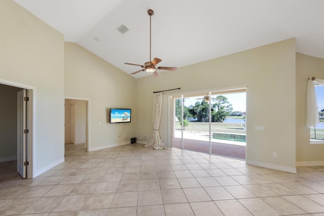 spare room with ceiling fan, high vaulted ceiling, baseboards, light tile patterned floors, and visible vents