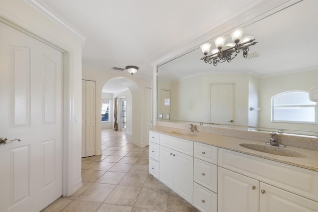 bathroom with a sink, tile patterned flooring, double vanity, and a chandelier