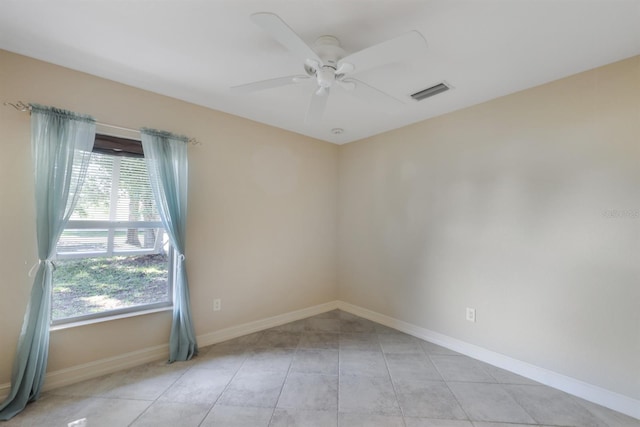spare room with visible vents, baseboards, ceiling fan, and light tile patterned floors