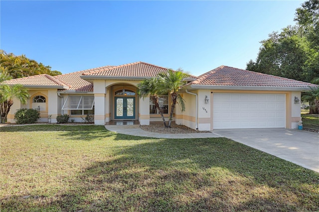 mediterranean / spanish-style home featuring a garage, stucco siding, french doors, concrete driveway, and a tile roof