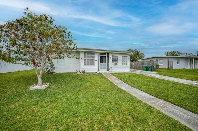2321 Dallas St, Port Charlotte, FL 33952 - view of front of property with fence and a front lawn