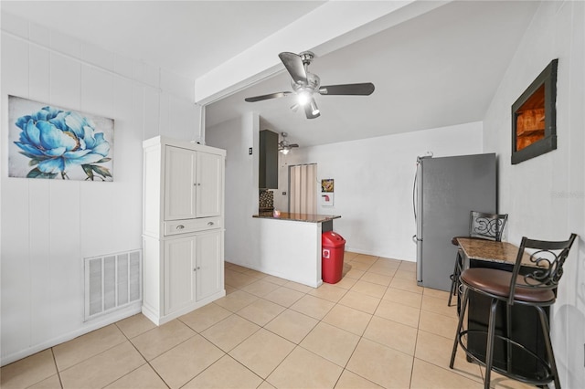 2321 Dallas St, Port Charlotte, FL 33952 - kitchen featuring a ceiling fan, visible vents, light tile patterned floors, freestanding refrigerator, and white cabinetry