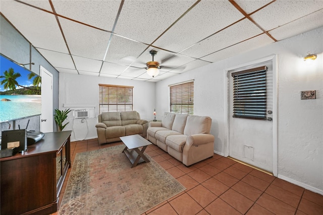 2321 Dallas St, Port Charlotte, FL 33952 - living area with baseboards, a ceiling fan, tile patterned floors, and a paneled ceiling