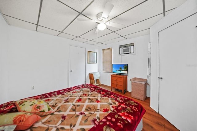 2321 Dallas St, Port Charlotte, FL 33952 - bedroom with a wall mounted air conditioner, a ceiling fan, and wood finished floors