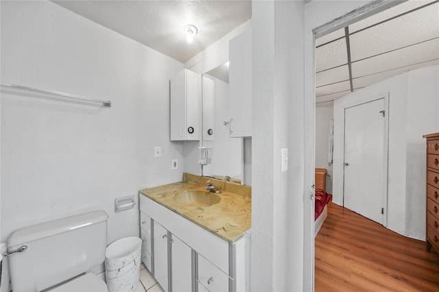 2321 Dallas St, Port Charlotte, FL 33952 - bathroom with vanity, wood finished floors, and toilet