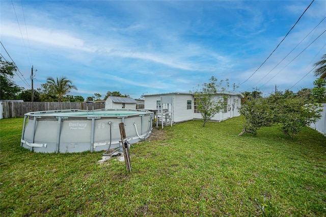 2321 Dallas St, Port Charlotte, FL 33952 - view of yard featuring an outdoor structure, fence, and a fenced in pool