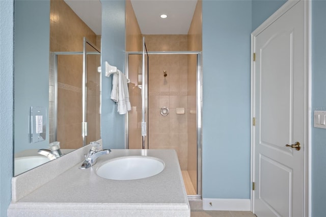 full bath with a stall shower and a sink