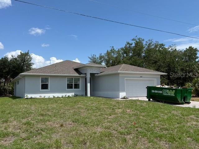 384 Prineville St, Port Charlotte, FL 33954 - view of front of property featuring a garage, a front lawn, and stucco siding