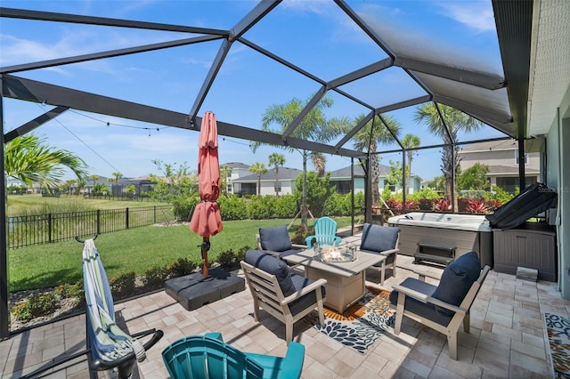 view of patio / terrace featuring a hot tub, fence, a lanai, and an outdoor fire pit