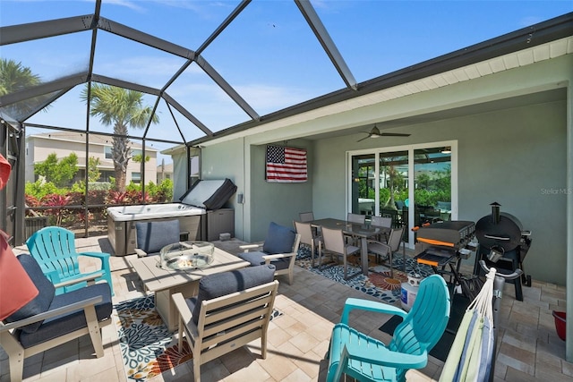 view of patio with outdoor dining area, ceiling fan, and a lanai
