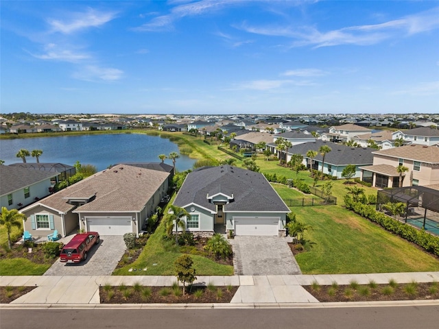 drone / aerial view with a residential view and a water view
