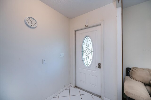 2113 Barksdale St, Port Charlotte, FL 33948 - foyer entrance featuring light tile patterned flooring and baseboards