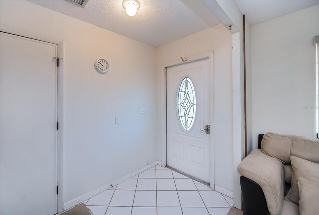 2113 Barksdale St, Port Charlotte, FL 33948 - foyer featuring a textured ceiling and baseboards