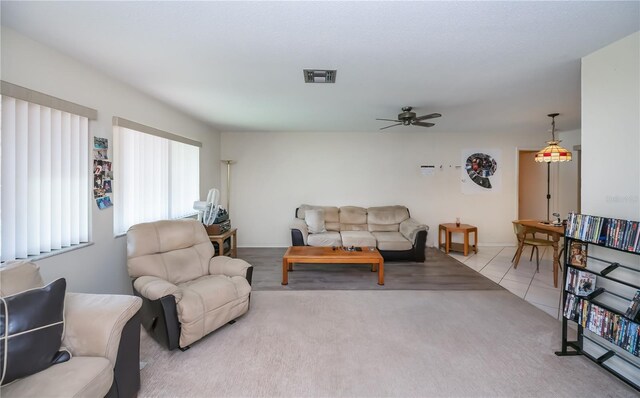 2113 Barksdale St, Port Charlotte, FL 33948 - carpeted living room featuring ceiling fan, tile patterned floors, and baseboards