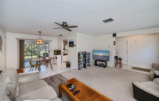 2113 Barksdale St, Port Charlotte, FL 33948 - living room with a textured ceiling, ceiling fan, light tile patterned flooring, and baseboards