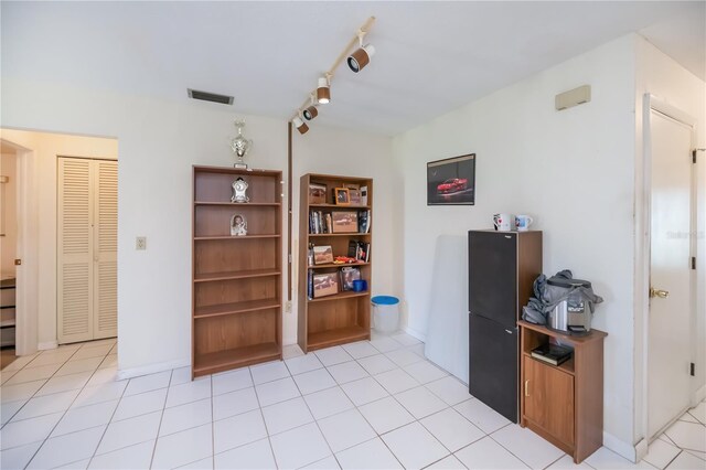 2113 Barksdale St, Port Charlotte, FL 33948 - office featuring rail lighting, light tile patterned floors, and baseboards