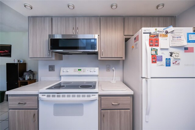 2113 Barksdale St, Port Charlotte, FL 33948 - kitchen featuring white appliances, light countertops, and gray cabinetry