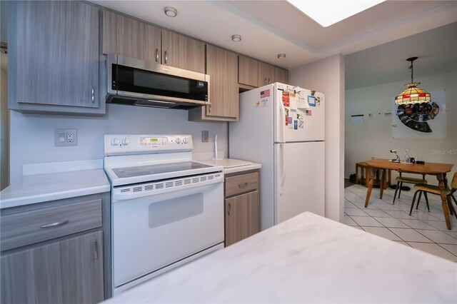 2113 Barksdale St, Port Charlotte, FL 33948 - kitchen with white appliances, light countertops, light tile patterned flooring, and pendant lighting