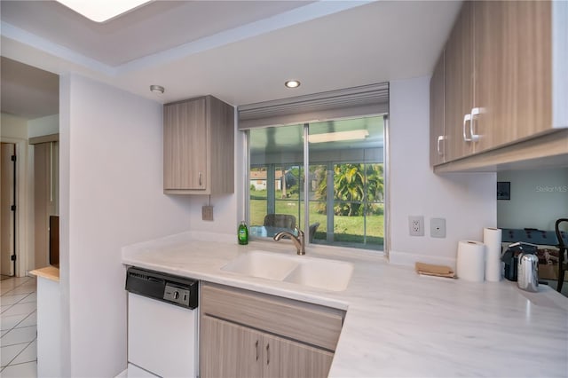 2113 Barksdale St, Port Charlotte, FL 33948 - kitchen with white dishwasher, a sink, light countertops, light brown cabinetry, and light tile patterned floors