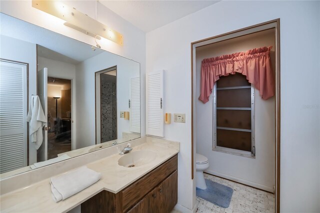 2113 Barksdale St, Port Charlotte, FL 33948 - bathroom featuring vanity, toilet, a closet, and tile patterned floors