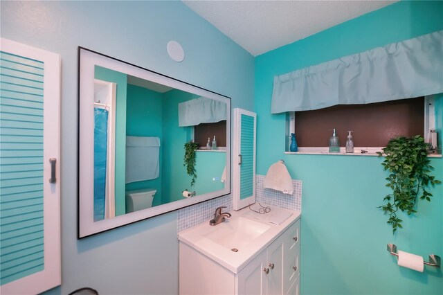2113 Barksdale St, Port Charlotte, FL 33948 - bathroom with toilet, vanity, and backsplash