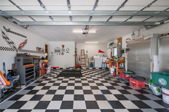 2113 Barksdale St, Port Charlotte, FL 33948 - garage featuring a garage door opener and washing machine and dryer