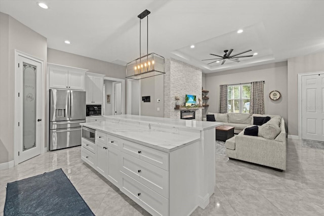 kitchen featuring white cabinets, ceiling fan, appliances with stainless steel finishes, a raised ceiling, and recessed lighting
