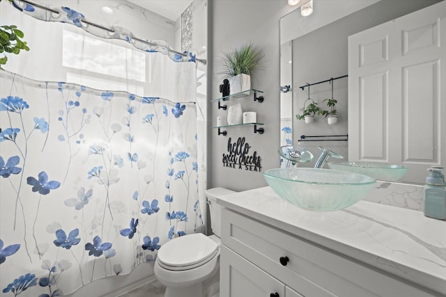 bathroom with toilet, shower / bath combination with curtain, and vanity