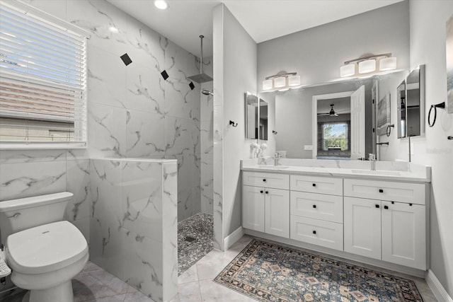 full bathroom with double vanity, a sink, a marble finish shower, and toilet