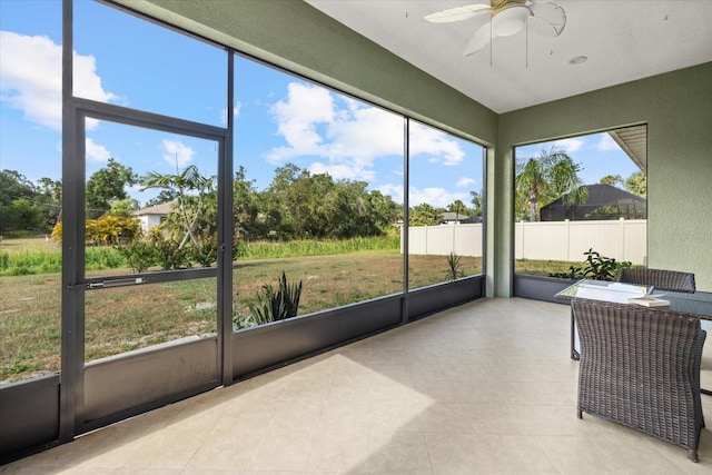 sunroom featuring ceiling fan
