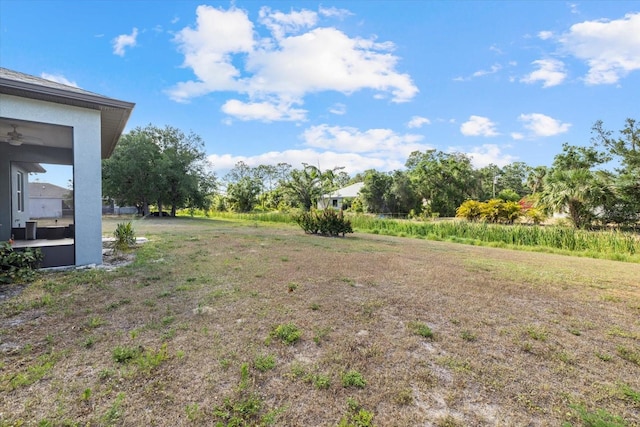 view of yard featuring a ceiling fan