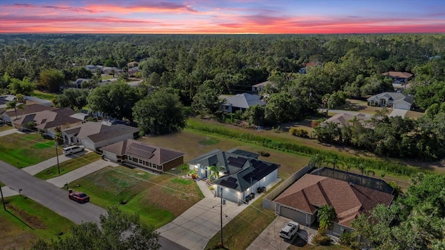 birds eye view of property featuring a forest view and a residential view