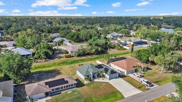 bird's eye view featuring a residential view and a wooded view
