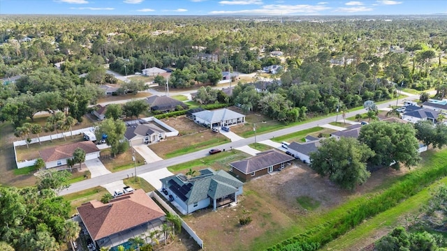 birds eye view of property featuring a residential view and a forest view