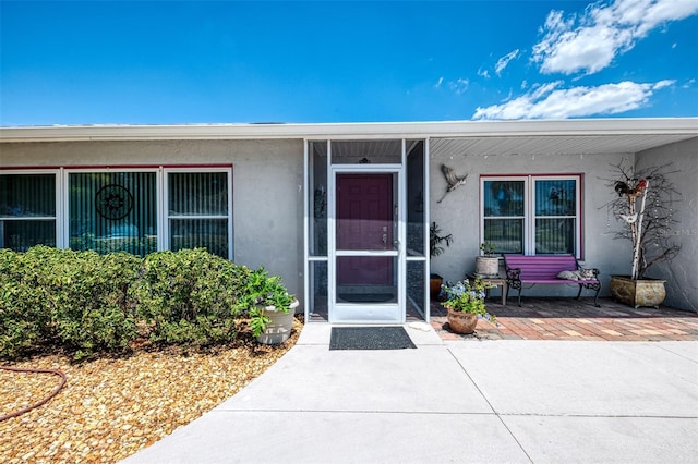 property entrance with stucco siding
