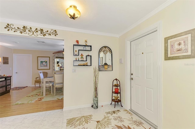 entryway with crown molding and baseboards