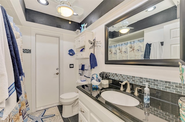 bathroom with vanity, tasteful backsplash, and toilet