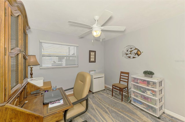 office area with baseboards, ceiling fan, and a baseboard heating unit