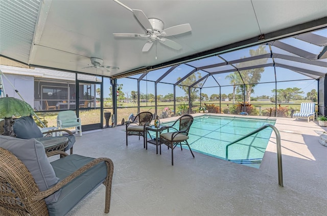 outdoor pool with glass enclosure, ceiling fan, an outdoor hangout area, and a patio area