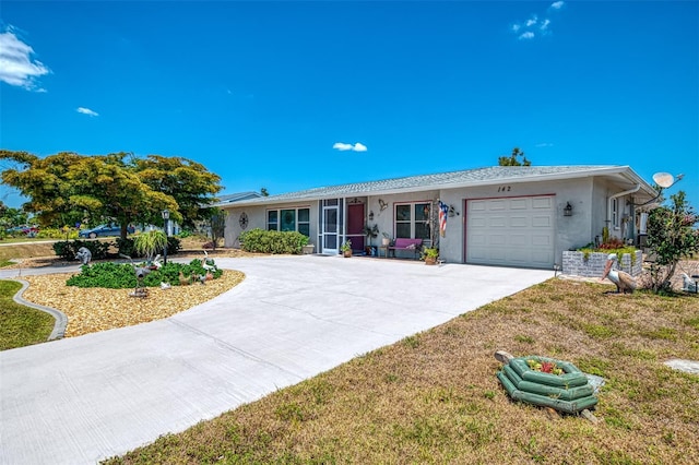 single story home featuring an attached garage, stucco siding, driveway, and a front yard